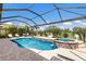 Stunning screened-in pool and spa with water features, lush landscaping, and golf course views at 5804 Mulligan Way, Lakewood Ranch, FL 34211