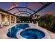 Beautiful in-ground screened pool and spa with mature landscaping provides a relaxing outdoor retreat at 5804 Mulligan Way, Lakewood Ranch, FL 34211