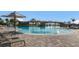 Resort style pool surrounded by lounge chairs and palm trees, creating a relaxing oasis at 5804 Mulligan Way, Lakewood Ranch, FL 34211