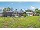 Large backyard featuring a screened-in pool area, a storage shed, and mature trees at 6002 34Th W Ave, Bradenton, FL 34209