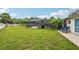 Lush backyard featuring a covered pool area, seating, and plenty of space for outdoor enjoyment at 6002 34Th W Ave, Bradenton, FL 34209