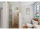 Elegant bathroom featuring a glass-enclosed shower with tiled walls and mosaic flooring at 6002 34Th W Ave, Bradenton, FL 34209