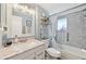 Updated bathroom with mosaic tile, updated vanity, framed mirror, and shower-tub combination at 6002 34Th W Ave, Bradenton, FL 34209