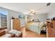 Inviting bedroom with light wood floors, natural light, and a comfortable queen-sized bed with patterned bedding at 6002 34Th W Ave, Bradenton, FL 34209