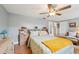 Comfortable bedroom with light wood floors, a ceiling fan, and a queen-sized bed with patterned bedding at 6002 34Th W Ave, Bradenton, FL 34209