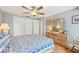 Bedroom showcasing wood floors, a closet, and natural wood furniture with a comfortable queen-sized bed at 6002 34Th W Ave, Bradenton, FL 34209