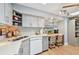 Open concept kitchen with white countertops, stainless steel sink, bar seating, and lots of natural light at 6002 34Th W Ave, Bradenton, FL 34209