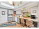 Bright kitchen with light cabinetry, a built-in desk area, and a view to the outside at 6002 34Th W Ave, Bradenton, FL 34209