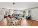 Bright living room features a comfortable seating arrangement, wood floors, and charming decorative touches at 6002 34Th W Ave, Bradenton, FL 34209
