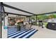 Charming covered patio with stylish furnishings and a barbecue grill, great for outdoor gatherings at 6002 34Th W Ave, Bradenton, FL 34209