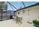 Outdoor dining on a screened-in patio with a shower and decorative elements at 6002 34Th W Ave, Bradenton, FL 34209