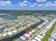 Aerial view of waterfront community with a river running between houses and a scenic background at 617 Fairmount Dr, North Port, FL 34287