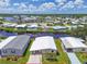 Aerial view of a home with a well-maintained lawn and canal frontage at 617 Fairmount Dr, North Port, FL 34287
