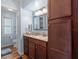 Bathroom with wooden cabinets, granite countertop, modern lighting, and a toilet room at 617 Fairmount Dr, North Port, FL 34287