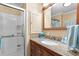 Bathroom with granite countertops, a bowl sink, and a shower with glass doors at 617 Fairmount Dr, North Port, FL 34287
