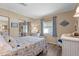 Serene bedroom featuring a comfortable bed, soft lighting, and wicker furniture at 617 Fairmount Dr, North Port, FL 34287