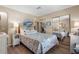 Cozy bedroom featuring laminated floors, a mirrored closet, and beach-themed decor at 617 Fairmount Dr, North Port, FL 34287