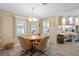 Cozy dining area with a round table, seating for four, and natural light at 617 Fairmount Dr, North Port, FL 34287