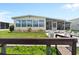 Charming home with lush lawn and landscaped flower bed and screened in porch at 617 Fairmount Dr, North Port, FL 34287