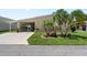 Charming home with a well-maintained lawn, carport, and lush landscaping at 617 Fairmount Dr, North Port, FL 34287