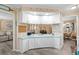 Bright kitchen featuring white cabinetry, blue countertops, and an open design flowing into other living spaces at 617 Fairmount Dr, North Port, FL 34287