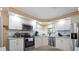 Well-lit kitchen featuring white cabinets, stainless steel appliances, and blue countertops at 617 Fairmount Dr, North Port, FL 34287