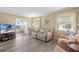 Comfortable living room with a sofa, natural light, and access to the lanai at 617 Fairmount Dr, North Port, FL 34287