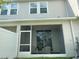 Back of home featuring a screened-in lanai, offering a private outdoor space, and a glimpse of the fenced yard at 6253 Whetstone Ct, Palmetto, FL 34221