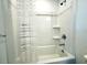 Bright bathroom showcasing a white shower-tub combo with modern chrome fixtures at 6253 Whetstone Ct, Palmetto, FL 34221