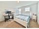 Bright bedroom featuring a bed, desk, white trim, and carpeted floors at 6253 Whetstone Ct, Palmetto, FL 34221