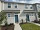 Inviting townhome exterior with landscaped yard and eye-catching, complementary-colored doors at 6253 Whetstone Ct, Palmetto, FL 34221