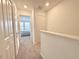 Upstairs hallway with bedrooms and neutral colored carpet at 6253 Whetstone Ct, Palmetto, FL 34221