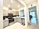 Stylish kitchen with stainless steel appliances and an open view into the living room at 6253 Whetstone Ct, Palmetto, FL 34221