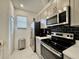 Modern kitchen featuring stainless steel appliances, black backsplash, and ample storage at 6253 Whetstone Ct, Palmetto, FL 34221