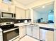 Well-equipped kitchen featuring stainless steel appliances and ample counter space at 6253 Whetstone Ct, Palmetto, FL 34221