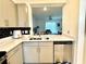 Modern kitchen featuring stainless appliances, white countertops, and a view to the living space at 6253 Whetstone Ct, Palmetto, FL 34221