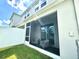 Back of home featuring a cozy screened-in lanai, offering a private outdoor space, and a glimpse of the fenced yard at 6253 Whetstone Ct, Palmetto, FL 34221