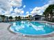 Enjoy the community pool with sun loungers, covered area and landscaped with palm trees for a resort-like experience at 6253 Whetstone Ct, Palmetto, FL 34221