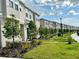 Charming street view with well-maintained lawns, lush landscaping, and sidewalks in front of the townhomes at 6253 Whetstone Ct, Palmetto, FL 34221