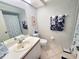Well lit bathroom featuring a toilet, vanity, and shower with a themed anchor motif at 6507 Stone River Rd # 302, Bradenton, FL 34203