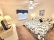 Bedroom featuring a ceiling fan, a window with blinds, and a nautical themed comforter at 6507 Stone River Rd # 302, Bradenton, FL 34203