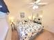 Bedroom featuring a ceiling fan, a window with blinds, mirrored closet, and nautical themed comforter at 6507 Stone River Rd # 302, Bradenton, FL 34203