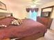 Bright bedroom featuring a ceiling fan, dresser with TV, and a sliding door leading to a balcony at 6507 Stone River Rd # 302, Bradenton, FL 34203