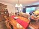 Charming dining room boasts hardwood floors, a decorative chandelier, and a view into the adjacent living area at 6507 Stone River Rd # 302, Bradenton, FL 34203