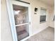 Condo entrance featuring a screen door, exterior light, and welcome mat at 6507 Stone River Rd # 302, Bradenton, FL 34203
