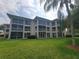 Screened-in balconies offer outdoor living space in this condo with tropical landscaping at 6507 Stone River Rd # 302, Bradenton, FL 34203