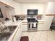 Well-lit kitchen featuring white cabinetry, modern appliances, and ample counter space for culinary enthusiasts at 6507 Stone River Rd # 302, Bradenton, FL 34203