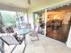 Screened patio with tile floor features a dining table with views to the interior living space at 6507 Stone River Rd # 302, Bradenton, FL 34203