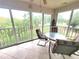 Screened patio featuring tiled floors, a ceiling fan, and a dining table with four chairs at 6507 Stone River Rd # 302, Bradenton, FL 34203