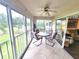 Enclosed patio with tile flooring and a dining table with four chairs at 6507 Stone River Rd # 302, Bradenton, FL 34203